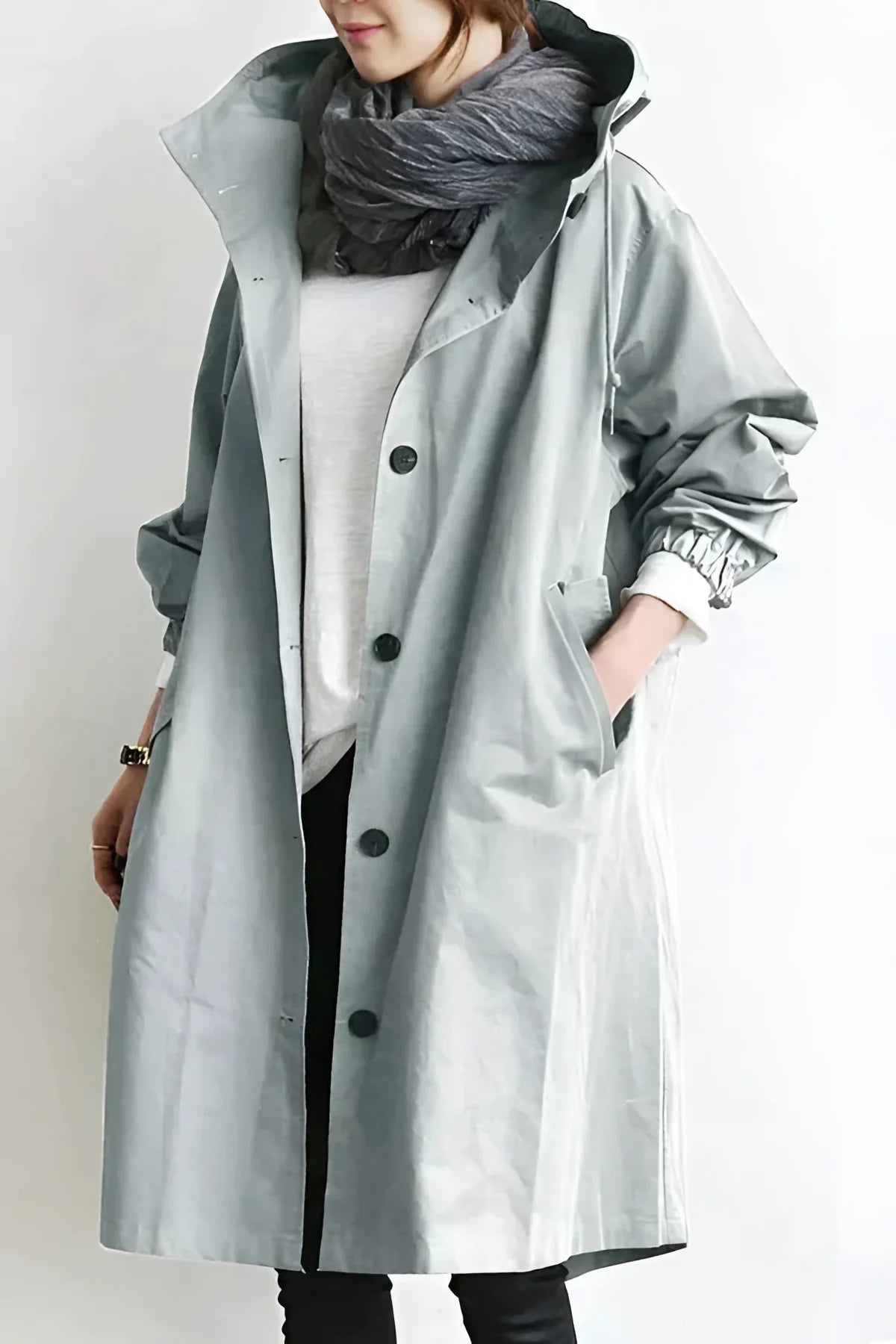 Stylish oversized gray women's hooded waterproof raincoat featuring long sleeves and a chic urban design.